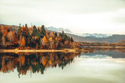 Reflection of trees in lake against sky during autumn