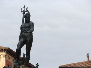 Low angle view of statue against sky