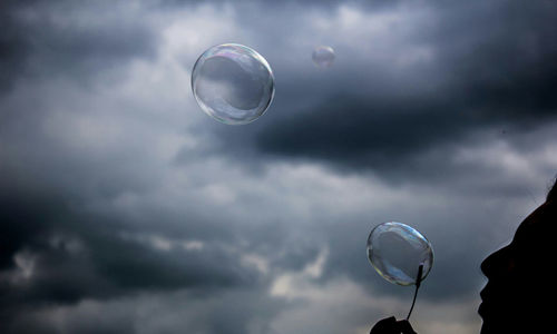 Low angle view of bubbles against sky