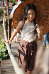 Portrait of young woman looking away outdoors