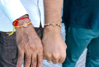 Midsection of man holding hands