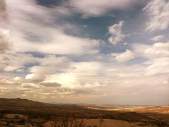 Scenic view of landscape against cloudy sky