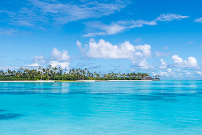 Scenic view of beach in maldives with pristine turquoise water and dramatic sky