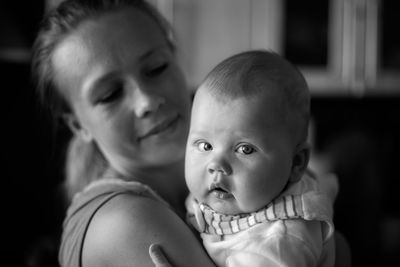 Portrait of baby with mother at home