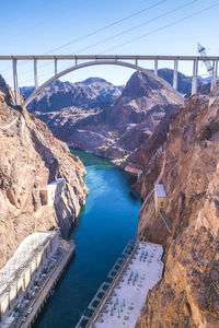 Arch bridge over river against sky