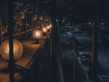 Illuminated street amidst buildings at night