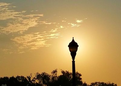 Low angle view of street light against sky during sunset