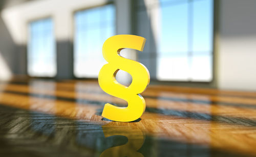 Close-up of yellow toy on wooden floor