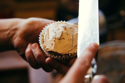 Close-up of hand holding ice cream