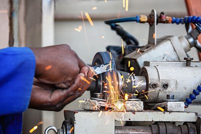 Cropped hand of man working in factory