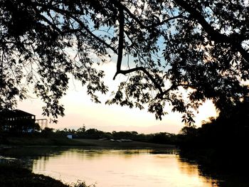 Scenic view of river at sunset