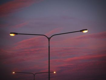 Low angle view of illuminated street light against sky