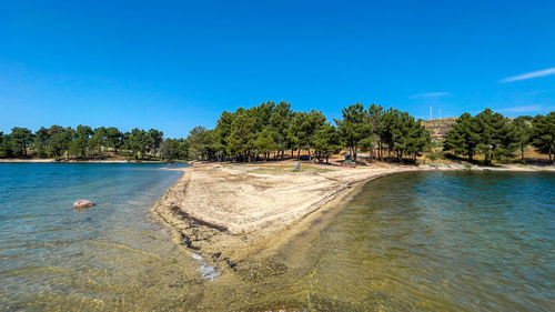 Scenic view of sea against clear blue sky