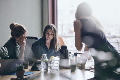 Confident female entrepreneurs planning strategy during meeting in board room at office