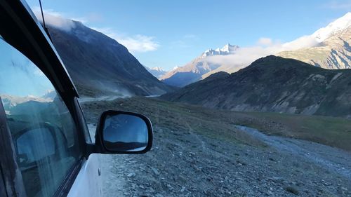 Scenic view of mountains against sky and rare view mirror reflection