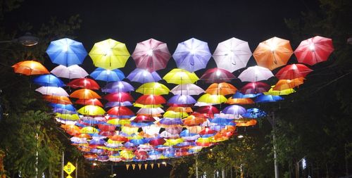 Low angle view of illuminated lanterns hanging at night