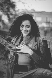 Smiling woman wearing scarf outdoors