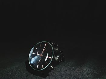 Close-up of clock against black background