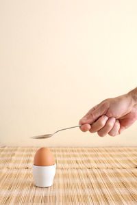 Close-up of hand holding ice cream on table
