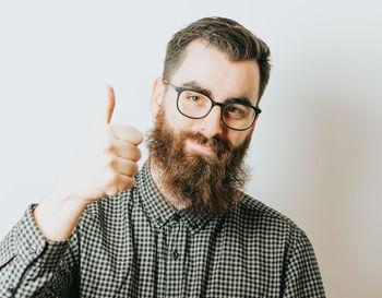 Portrait of young man against white background