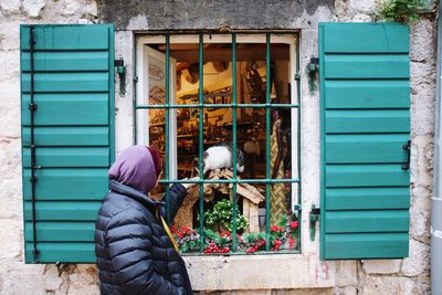 Man standing by window