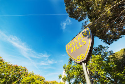 Low angle view of road sign against sky