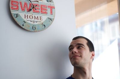 Portrait of young man against wall