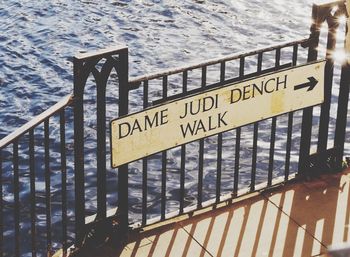 High angle view of text on railing against river