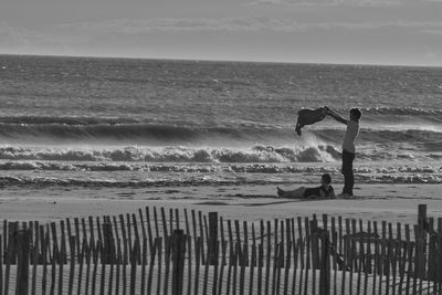 People on beach against sky