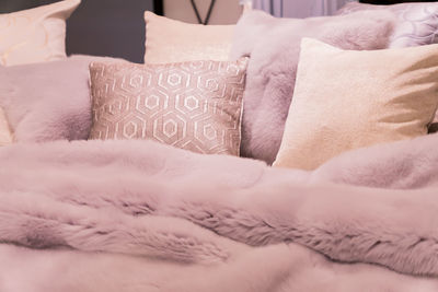 Pastep purple bedding - soft pillows and fur coverlet. coziness, comfort, interior  concept