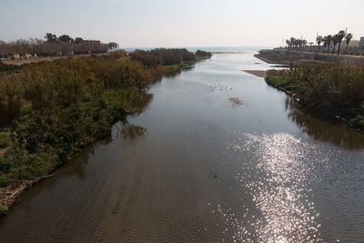 High angle view of sea and trees against sky