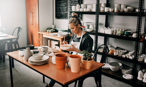 Woman sitting at table in workshop