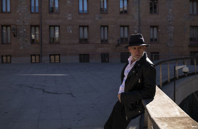 Portrait of adult man in hat and leather jacket on street. madrid, spain