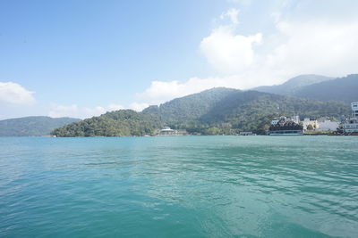 Scenic view of sea and mountains against sky