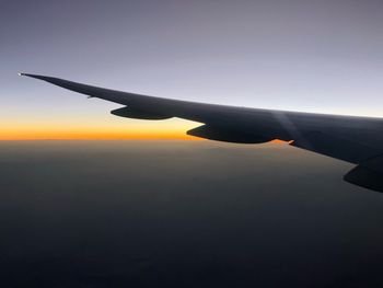 Airplane wing against clear sky