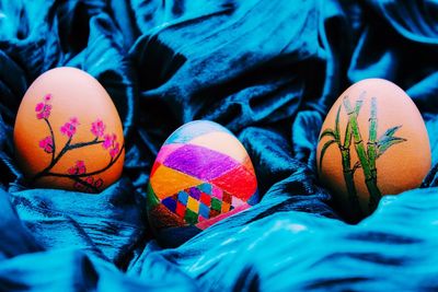 Close-up of painted easter eggs on blue fabric