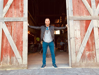 Full length portrait of happy man standing on floor