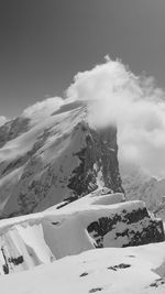 Scenic view of snow covered mountains against sky