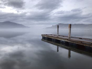 Pier on lake against sky