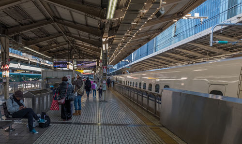 People walking on railroad station platform