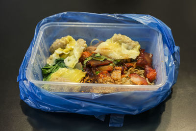 High angle view of char siu in lunch box on table