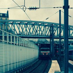 Railroad tracks with bridge in background