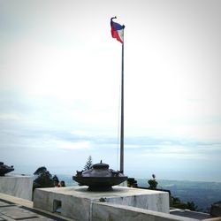 Flag on sea against sky