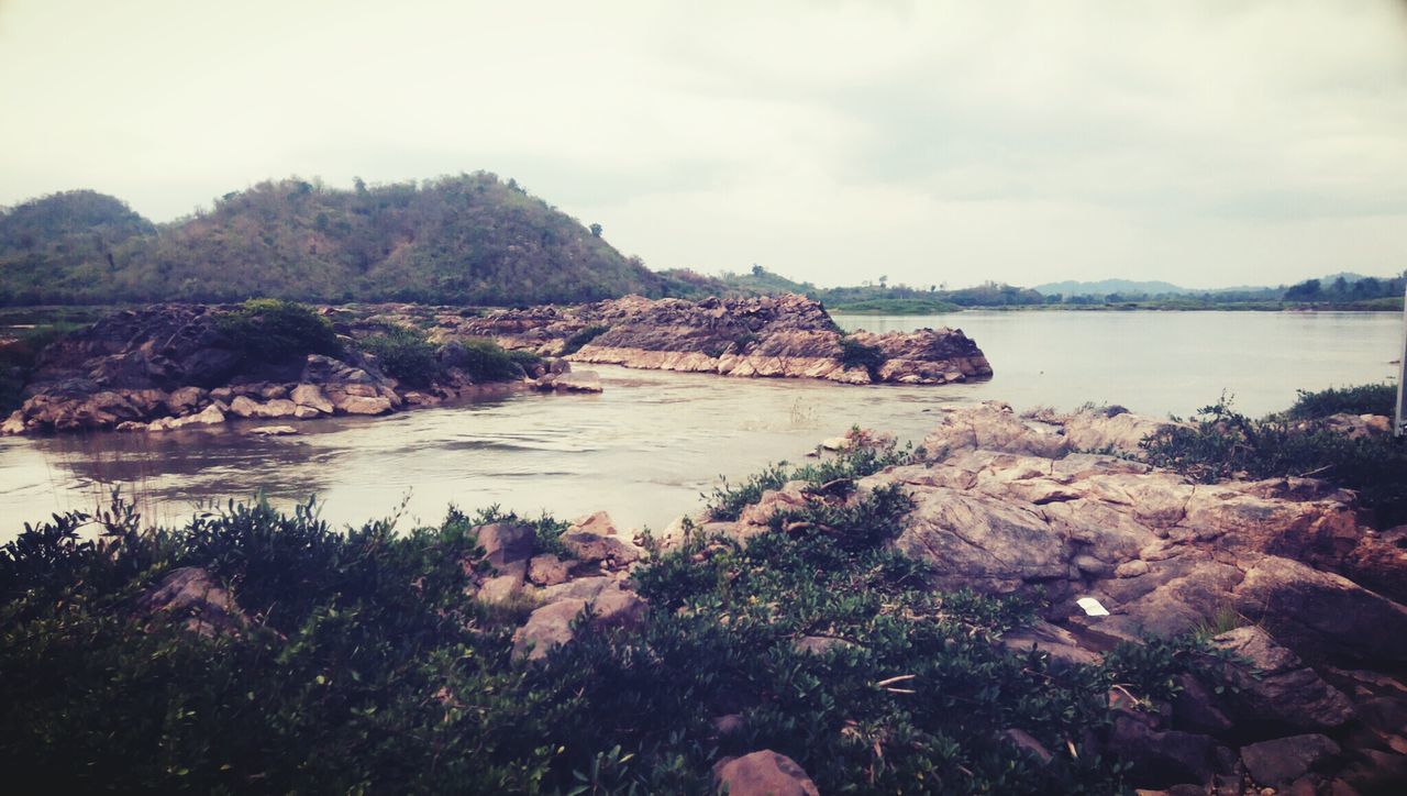 water, tranquil scene, tranquility, scenics, sky, beauty in nature, rock - object, nature, mountain, sea, lake, rock formation, idyllic, non-urban scene, rock, remote, calm, cliff, outdoors, cloud - sky