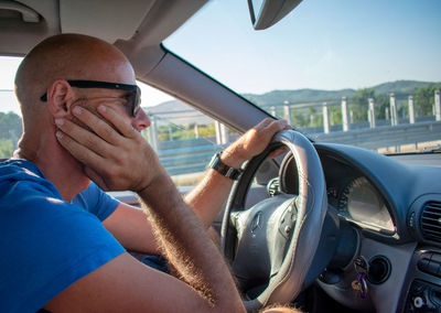 Portrait of man driving car