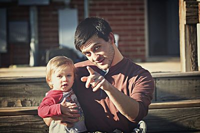 Portrait of smiling boy holding camera