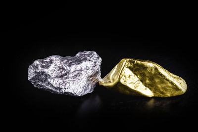 Close-up of bread on rock against black background