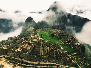 Aerial view of old ruin buildings on field 