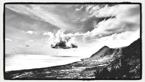 Scenic view of sea against cloudy sky