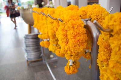 High angle view of marigold garlands hanging on hook